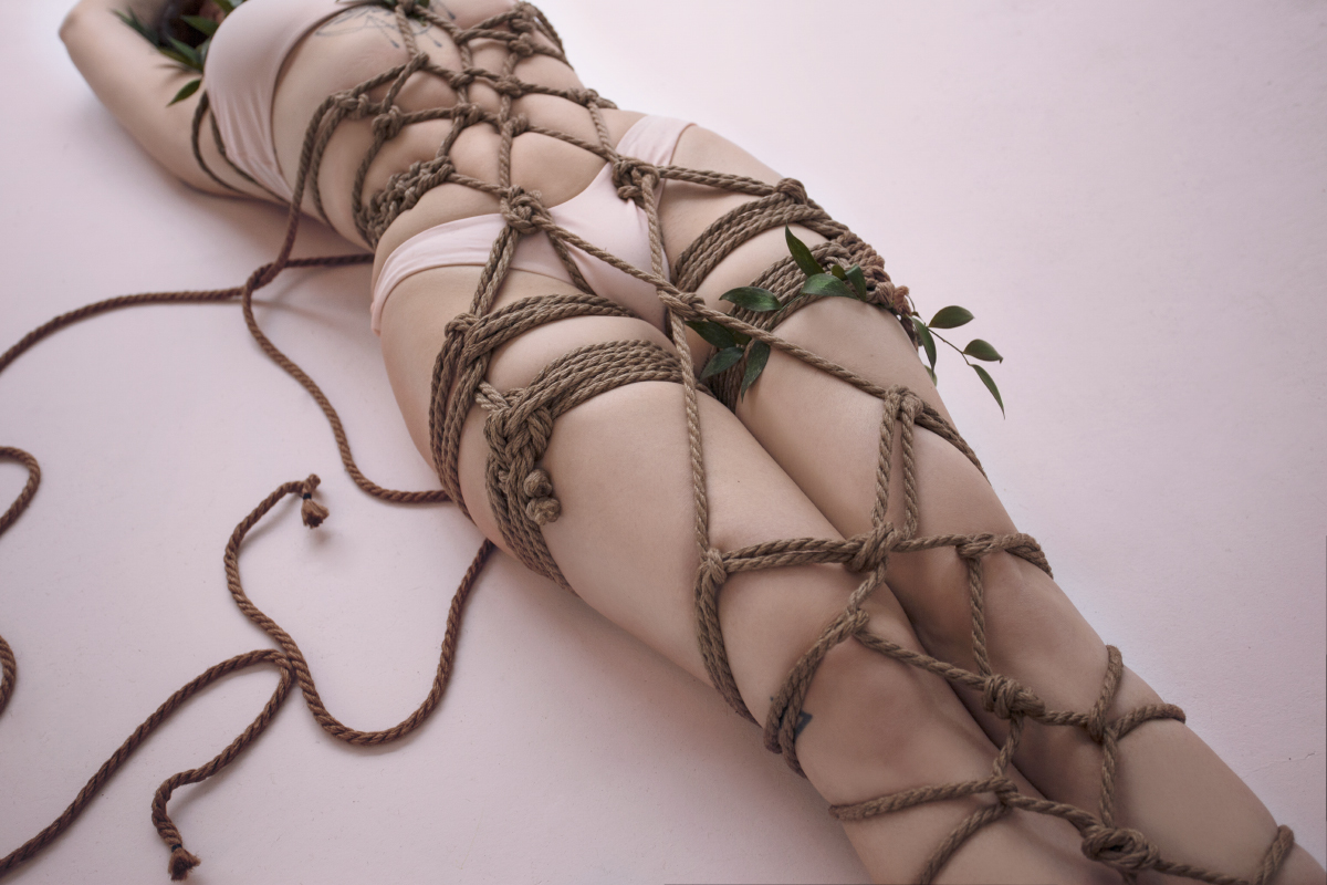 Bondage thumbs tied with rope