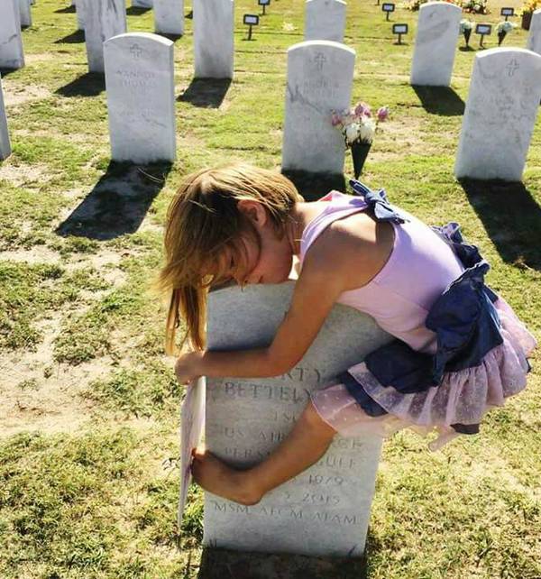 Little girl hugging her father's headstone - Girl, Death, Headstone, Father, Sadness, Daughter, Parents and children