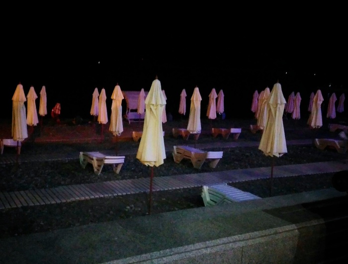 Folded umbrellas on the beach look like an army of ghost nuns. - Ghost, My, Sochi, Beach