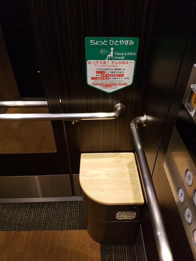 A chair in an elevator in Japan. In case the elevator gets stuck, it can be used as a toilet - Toilet, Japan, Elevator