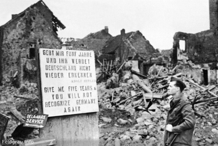 A soldier next to a sign with a quote from Hitler: Give me 5 years and you will not recognize Germany., Berlin, 1945. - Historical photo, Story, Germany, Berlin