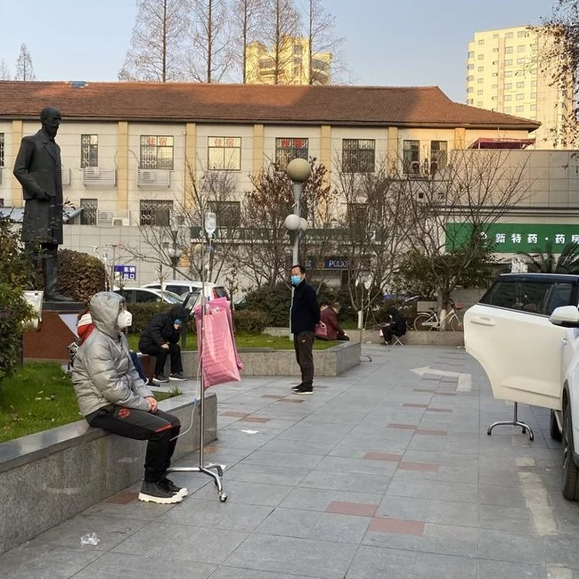 Patients with IVs sit outside so as not to become infected inside the hospital from other patients. Wuhan. China. 02/04/2020 - Wuhan, China, The photo, Dropper, Hospital, Coronavirus, Virus