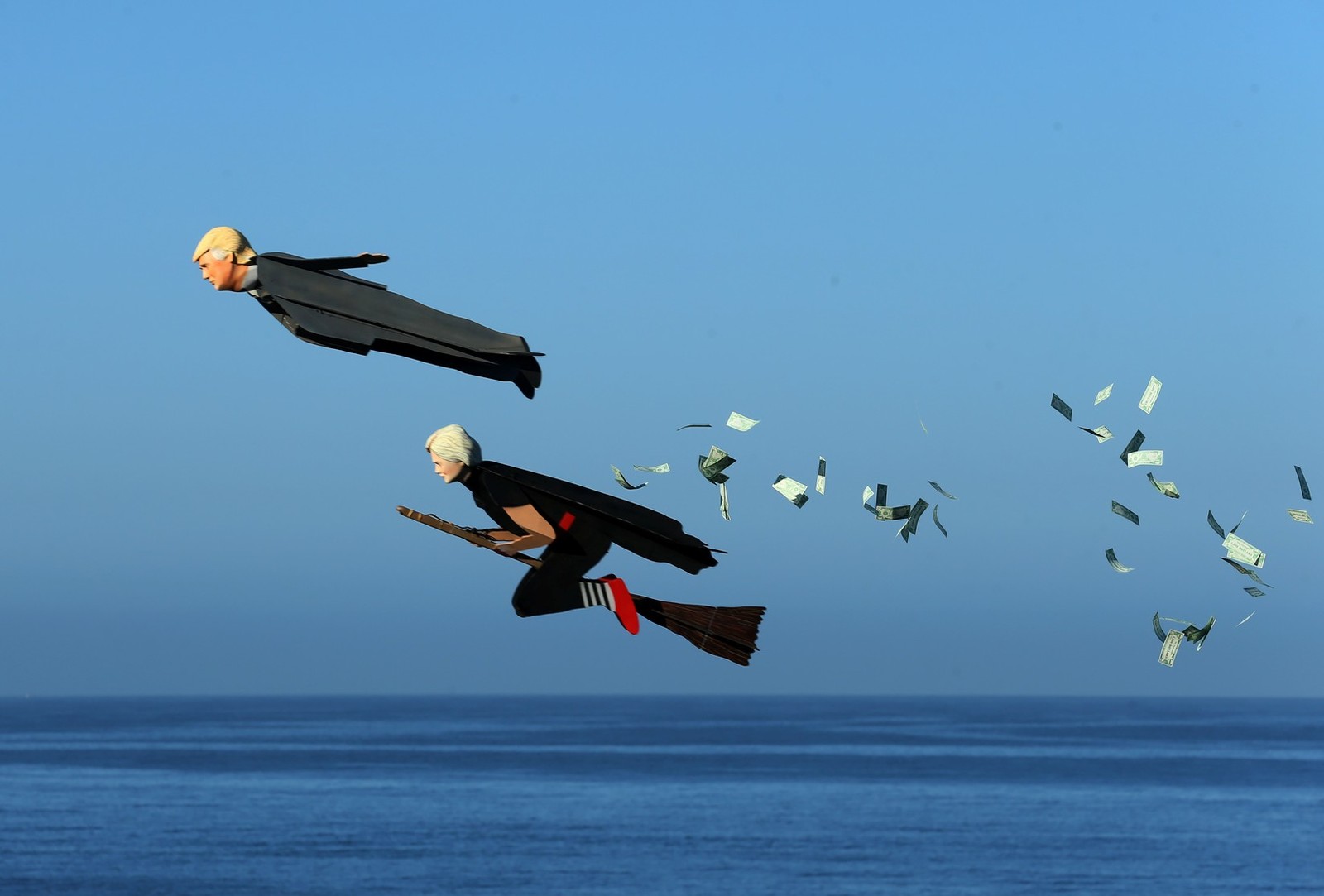 Model airplanes in the shape of money-scattering Donald Trump and Hillary Clinton on a broom fly over Carlsbad, California, USA. - US elections, USA, Trump, Donald Trump, , , Hillary Clinton, Elections