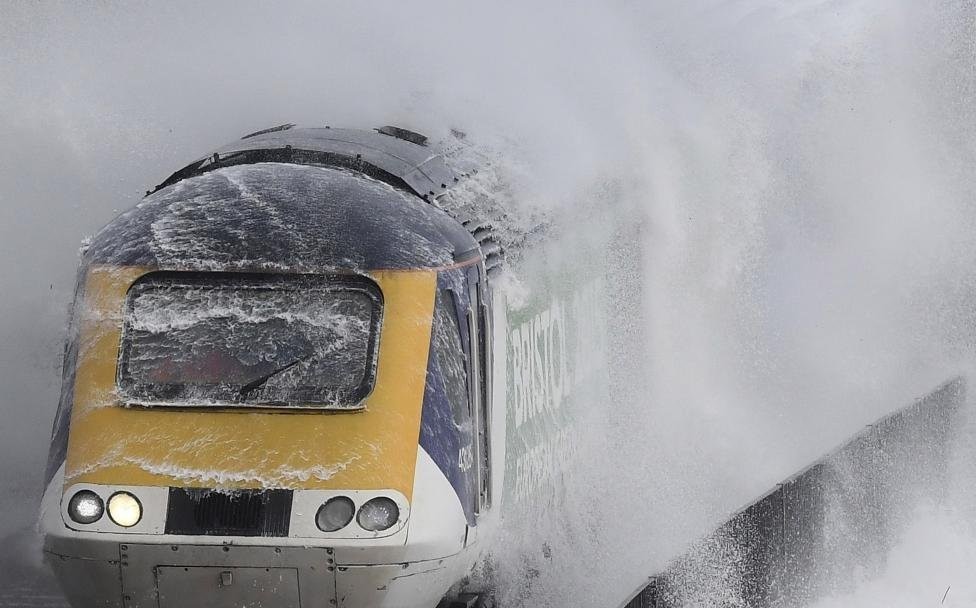 The train goes along the coast of the Atlantic Ocean during a storm. - Railway, Train, Atlantic, England