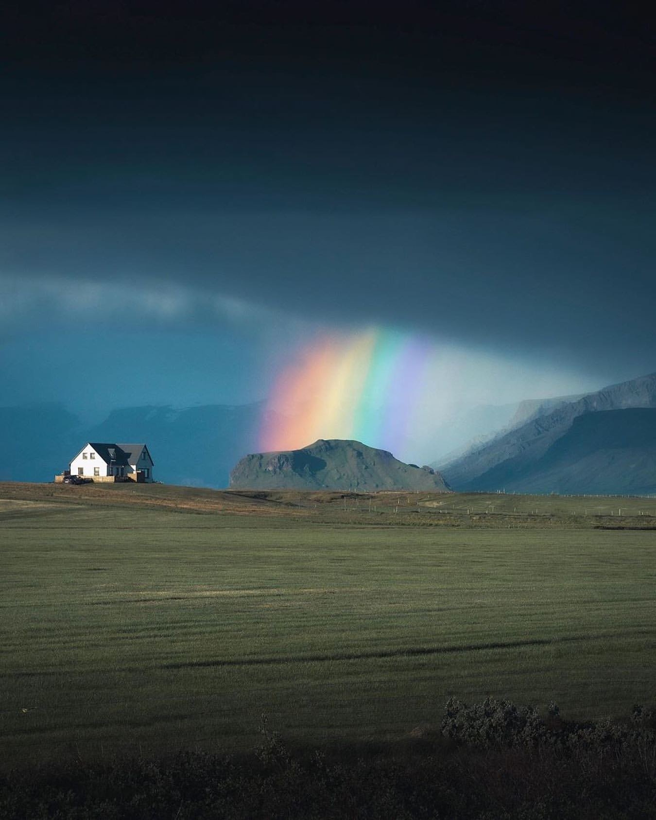 Giant rainbow in Iceland! - Rainbow, Iceland, The mountains, Field, The clouds, Sky, House, Reddit