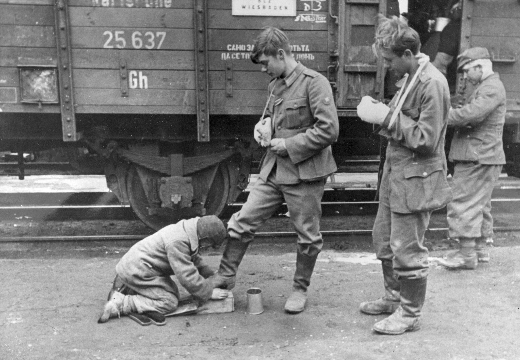 Untermensch cleaning the boots of a German soldier - The Great Patriotic War, An occupation, the USSR